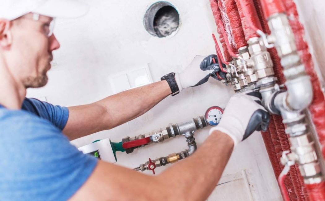 Expert Gas Installation Services for Safe System Setup Technician adjusting gas valves and pressure gauge during professional Gas Installation Services, ensuring safe and efficient system setup.