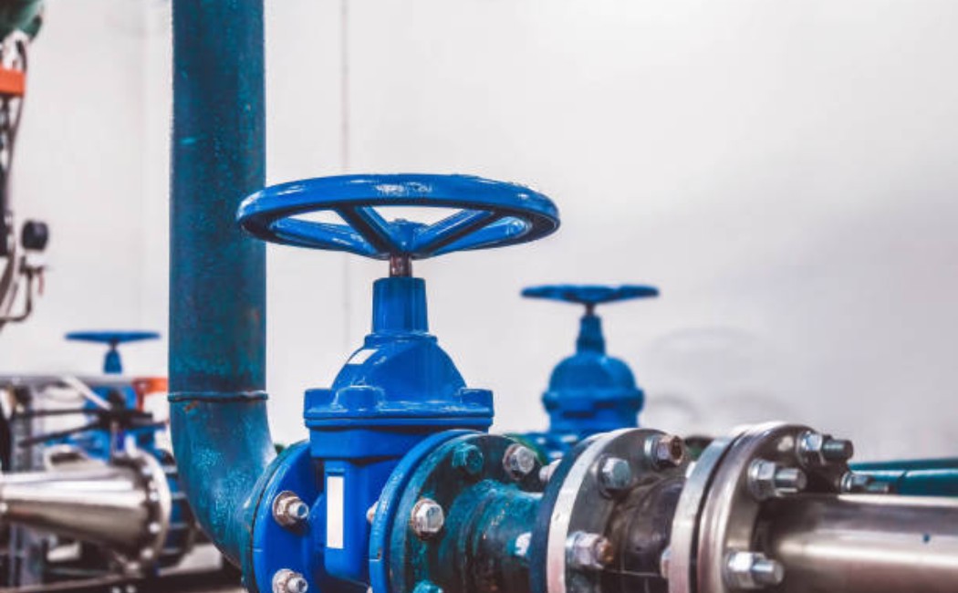 Professional Gas Installation Services: Industrial Pipeline with Blue Control Valves Industrial gas pipeline with blue control valves installed as part of professional Gas Installation Services, ensuring safe and regulated gas flow.