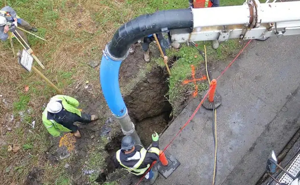 Technicians installing and fixing sewer infrastructure during a professional sewer line repair project.