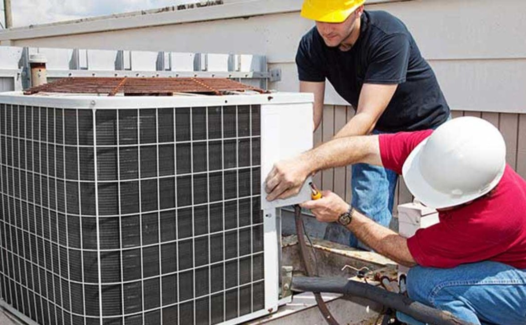 Expert HVAC Installation for Outdoor AC Unit Setup. Specialist performing HVAC Installation Services while installing and securing an outdoor air conditioning unit.